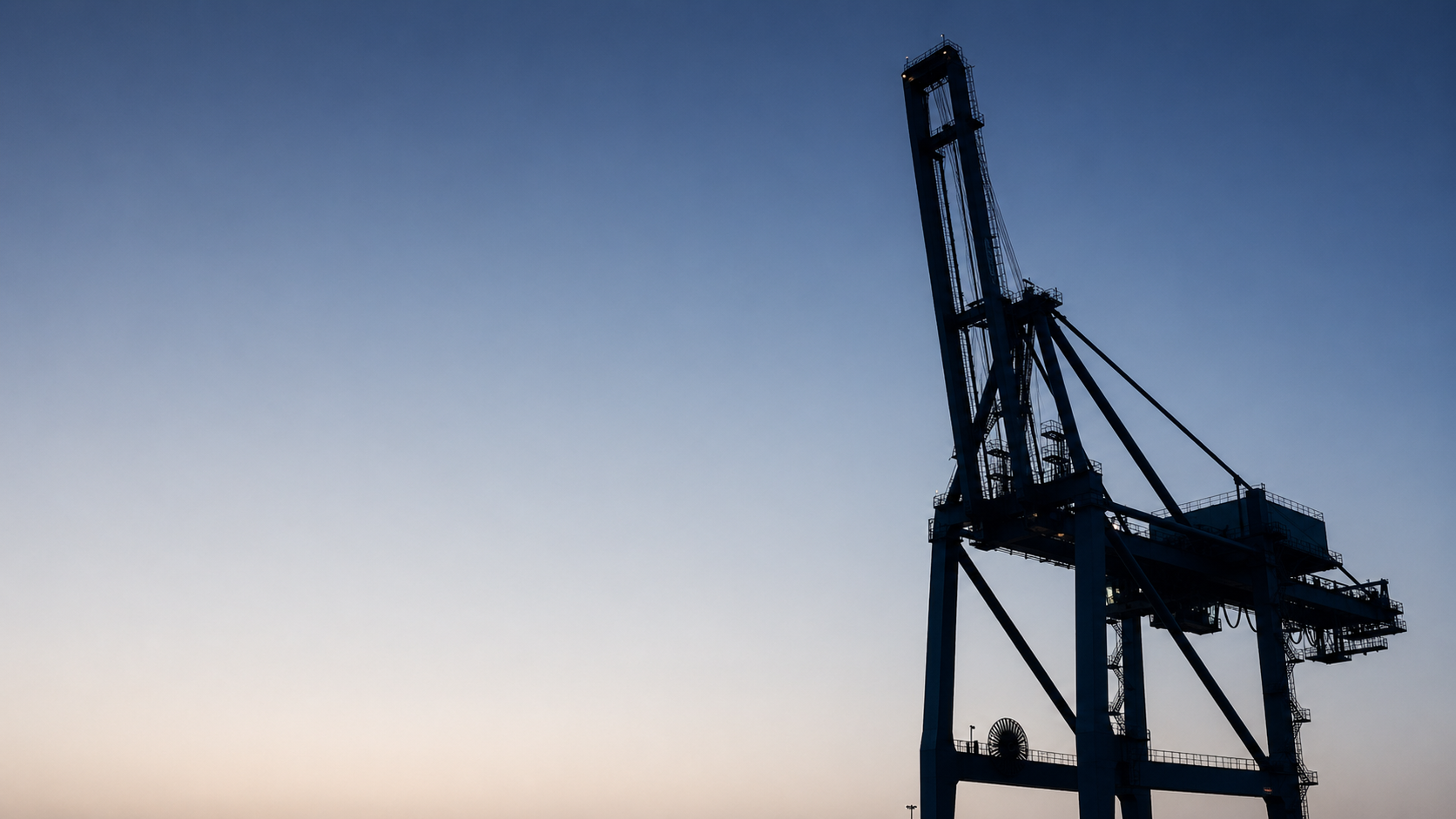 Shipping crane silhouette at dusk